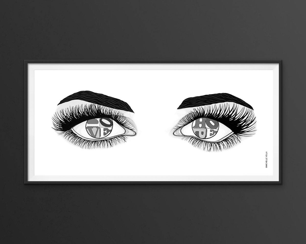 Eyes of Hope and Love is a wall art print of two eyes with the words Hope & Love written in the eyeballs in the style of Robert Indiana's LOVE, a pop art painting in B&W by Michelle Vella.